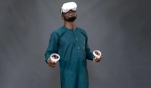 An African-origin man using VR headset and accessories