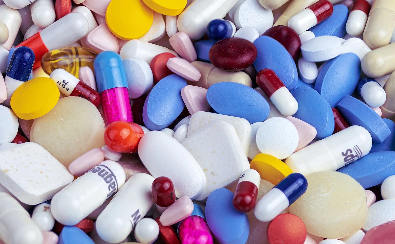 Blockchain Technology in Healthcare A colorful mix of different tablets and capsules