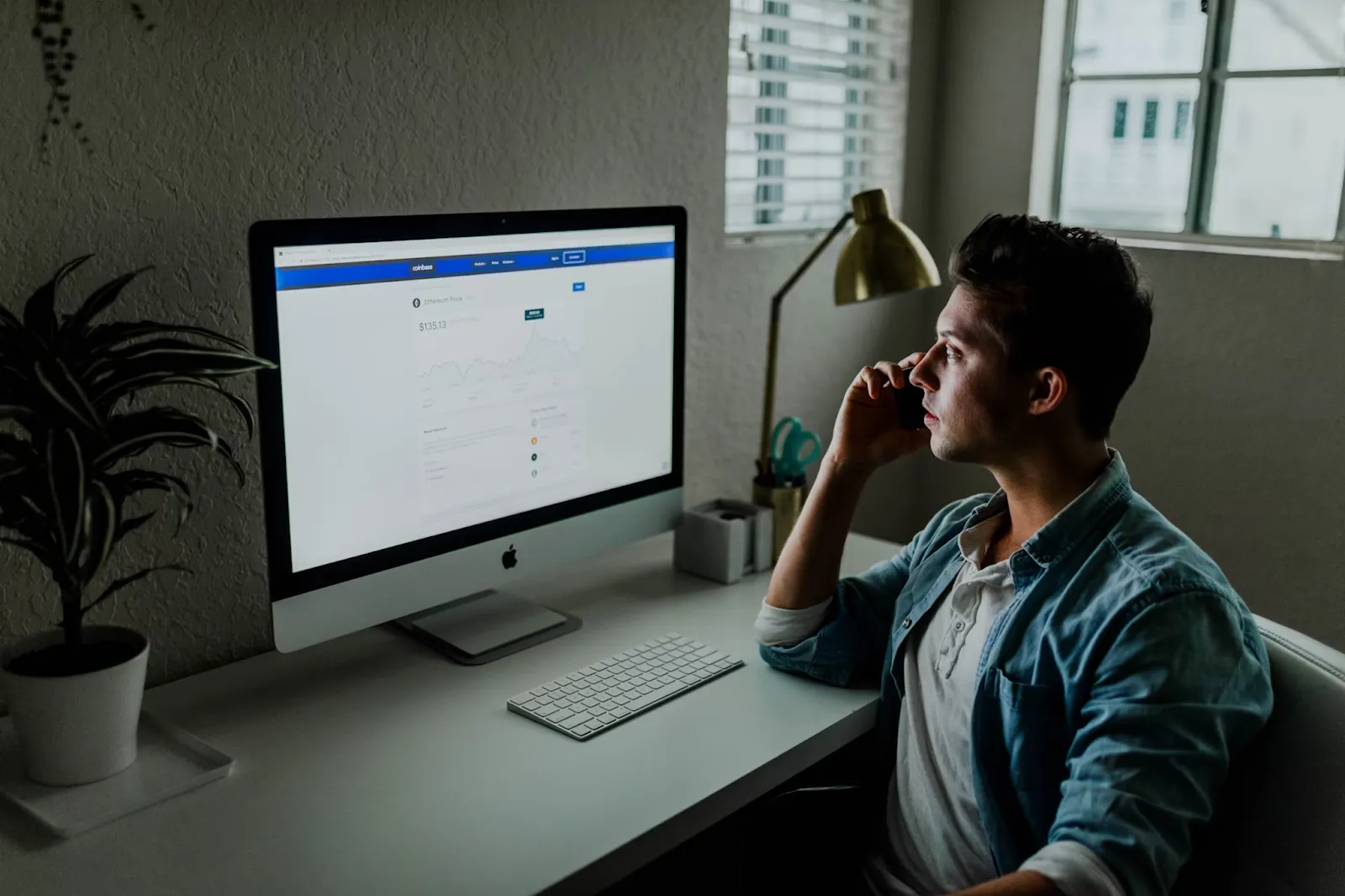 Real estate blockchain A guy watching tokenized asset chart on iMac